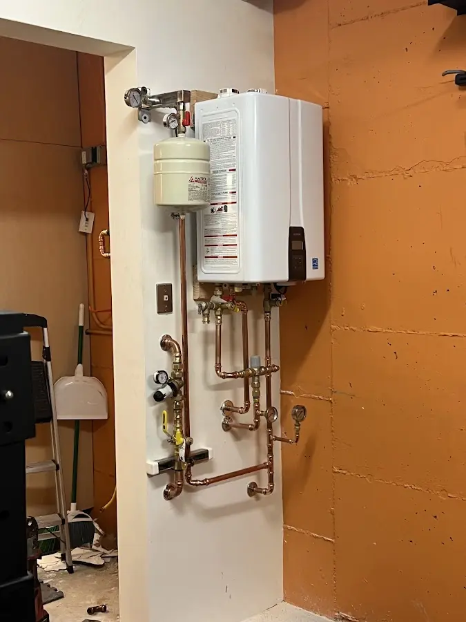 Plumbing technician inspecting water heater connections in Louisiana